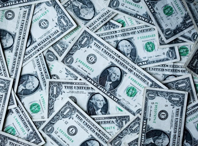 a pile of dollar bills